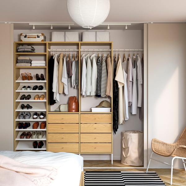 Organised closet with AURDAL oak storage, clothes, and lights.