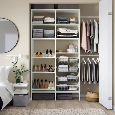 White storage system with shelves, drawers, and hanging rods in organised closet.