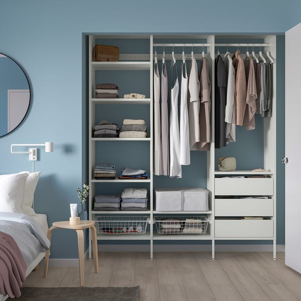 Ordered AURDAL closet in blue bedroom, with bed & mirror.