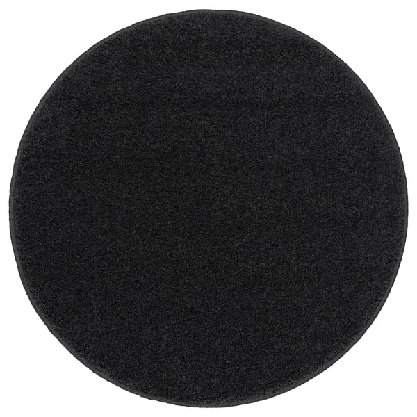 BACKMÅRA bath mat, black, round, soft, recycled polyester, latex backing, fluffy texture.