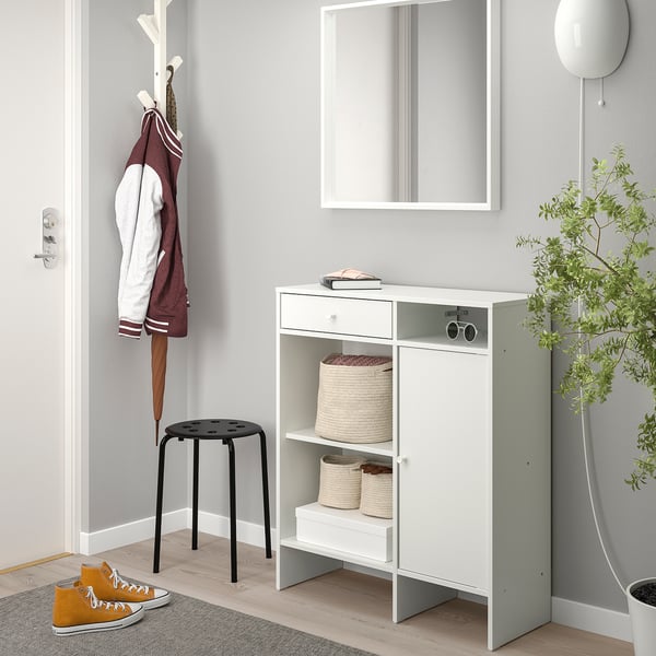 White mid-sized sideboard in hallway with baskets, drawer, mirror, stool & coat stand.