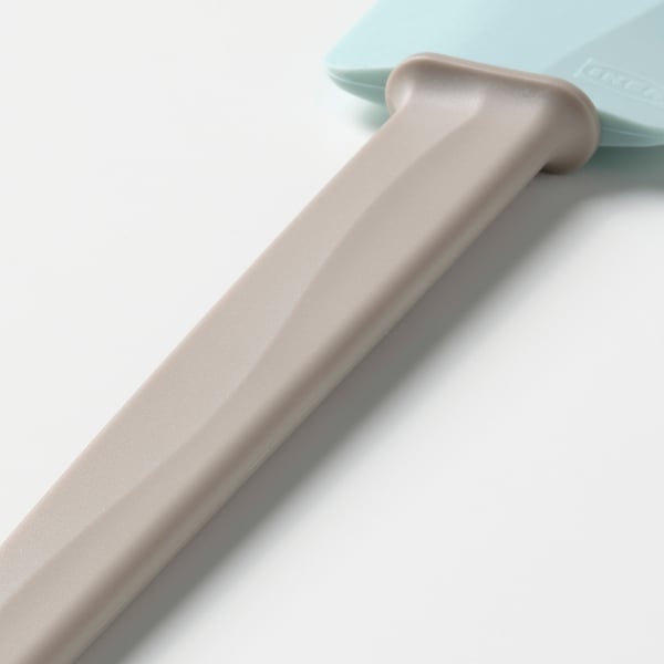 Light grey kitchen tool with a blue spatula tip, featuring smooth surface and ergonomic design.