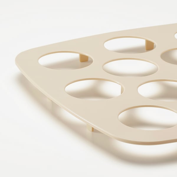 Cream-colored plastic cupcake holder with 12 slots and carry handles, designed for holding and protecting cupcakes.