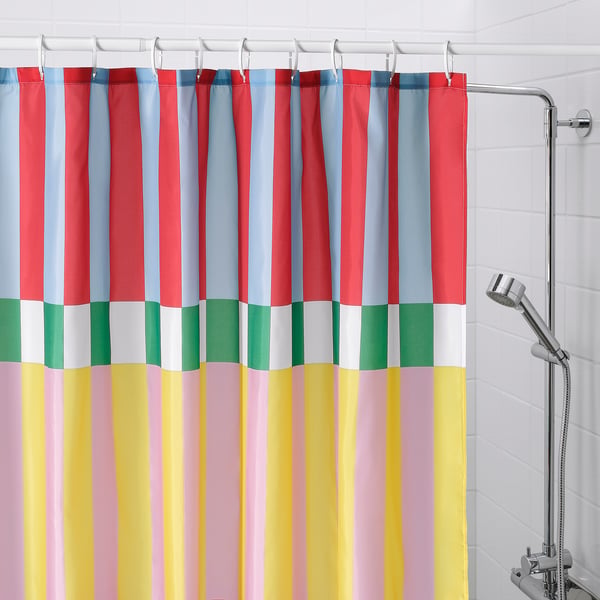 BANJANTRÄD shower curtain with colourful stripes in bathroom.