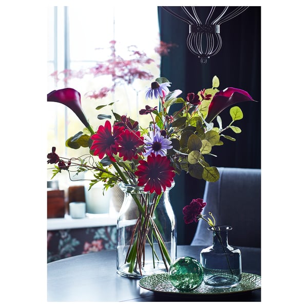 Elegant vase with colourful flowers, glass, clear, cylindrical, dark room, decorative.
