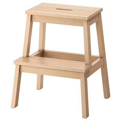 BEKVÄM step stool, natural wood. Two-tiered, rectangular design with hand-hole on top for easy movement. Solid wood, sturdy and stable.
