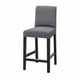 The BERGMUND barstool a grey fabric seat and backrest on black metal legs, designed for comfort with a modern look.