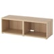 An ikea BESTÅ tv bench in white-stained oak effect. It is rectangular with open compartments and adjustable feet.