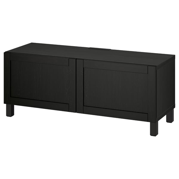 Black rectangular tv stand, made of wood and metal, with two doors and square legs. Part of IKEAs BESTÅ series.