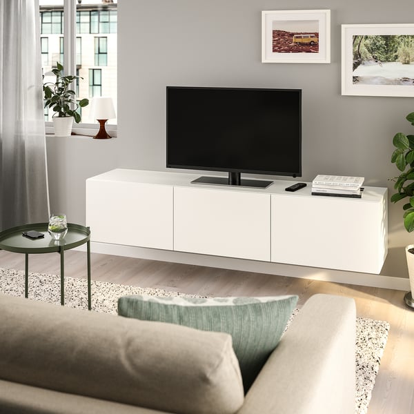 Modern living room with BESTÅ tv bench, minimalist design, grey sofa, and wall-mounted tv.