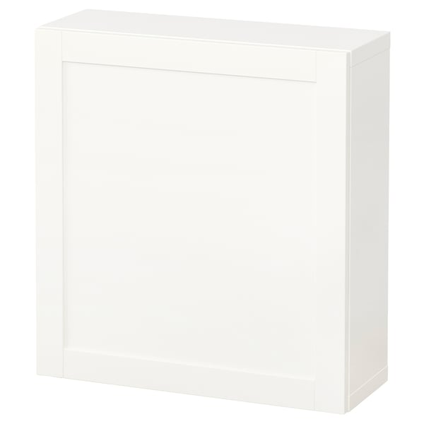 A white BESTÅ storage unit with a single door and adjustable shelves.