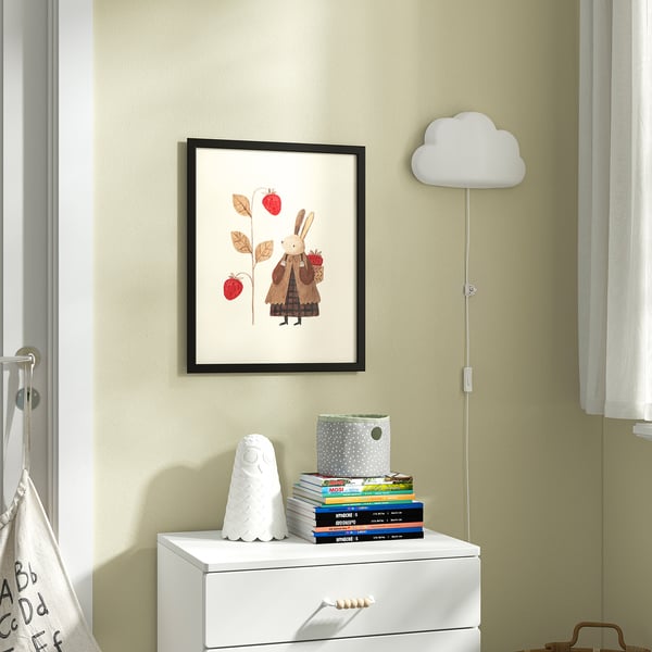 Picture of rabbit with apples above drawer of books & decor.