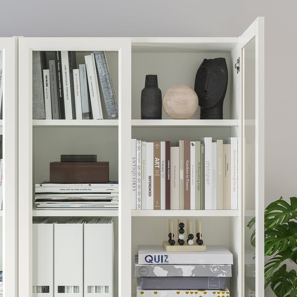 White BILLY bookcase with adjustable shelves, displaying books and decorative items.