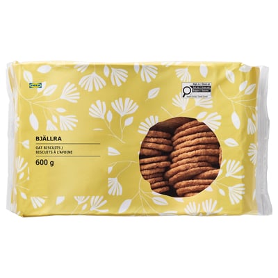 Package of IKEA BJÄLLRA oat biscuits, 600g, with floral design and cookies visible through window.