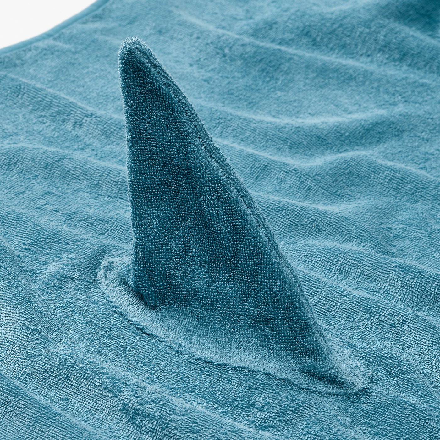 Soft blue shark towel with hood, crafted from warm, absorbent cotton terry. Perfect for kids, creates a playful experience post-bath.