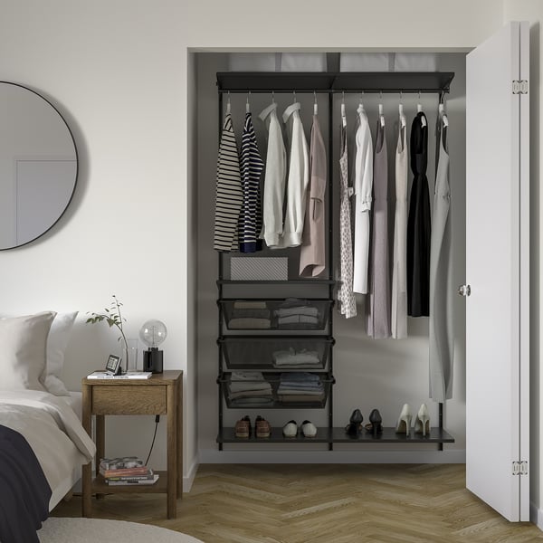 Open wardrobe: BOAXEL black metal, hanging clothes, shelves, and mesh baskets. Fits nicely in bedroom, organised, modern design.