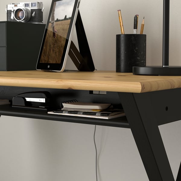 Desk with wooden top, shelf for stationery, cable management, and tablet stand.
