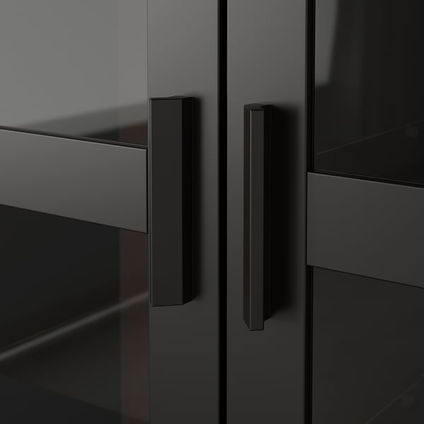 Modern black cabinet with sleek handles; reflects clean design and quality craftsmanship.