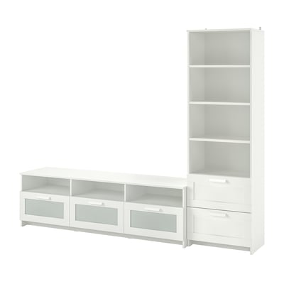 A white BRIMNES storage combination, including a wide tv stand with glass-fronted drawers and an adjacent tall bookcase with adjustable shelves.