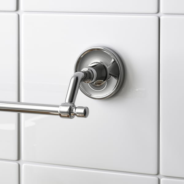 Chrome towel bar on white tiles, modern design with hidden screws.