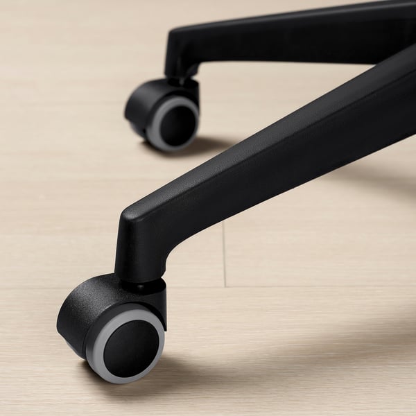 Close-up of black office chair casters, showcasing smooth, sturdy design.