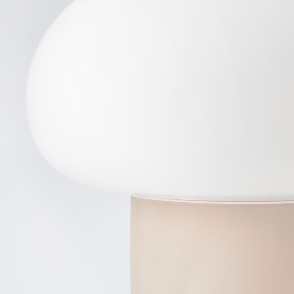 Modern lamp with sleek, curves and chrome details, emitting soft, warm light.