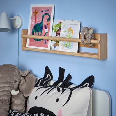 Large stuffed elephant, grey, soft, recyclable polyester, fits in backpack, part of DJUNGELSKOG collection, next to colourful art shelf.