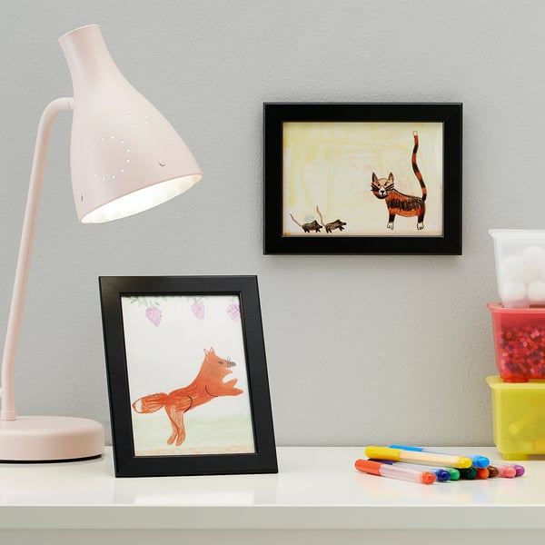 Desk with kids art: fox & cat, lamp, markers.