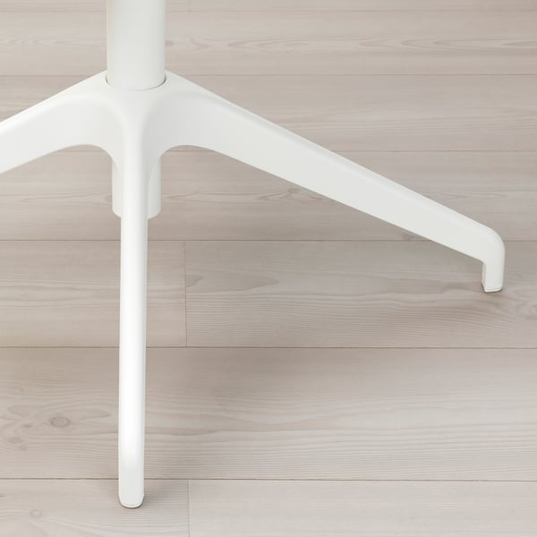 Modern minimalist chair leg detail, smooth white finish, sleek design, on light wooden floor.