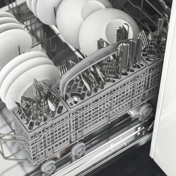 Open dishwasher shows cutlery basket, holding forks, knives, and spoons, arranged neatly in compartments, ready for washing.
