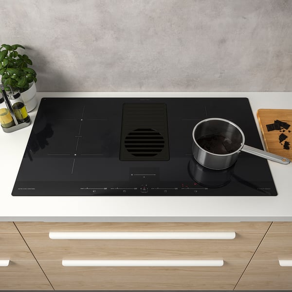 Induction cooktop with automated hood, digital controls.