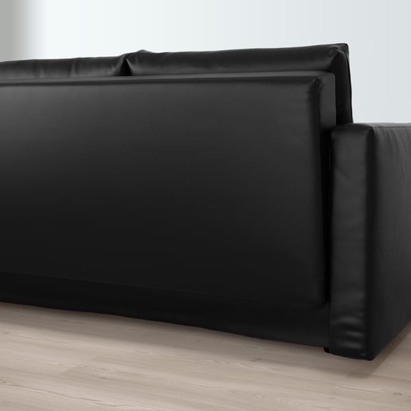 Black leather sectional sofa with wide seating and fixed cushions, ideal for convertible use.