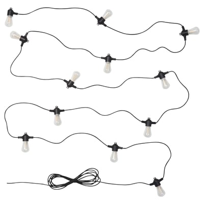Black outdoor string lights with vintage bulbs, shaped for garden decor.