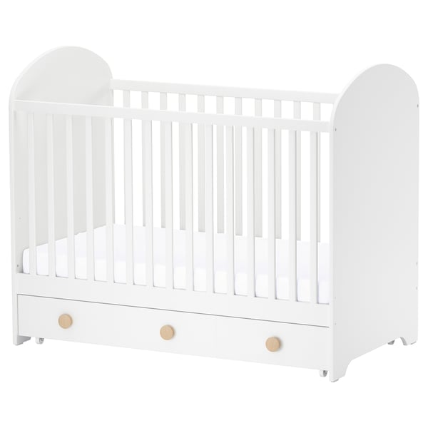 White GONATT baby crib with wooden knobs, slatted sides, and bottom drawer.