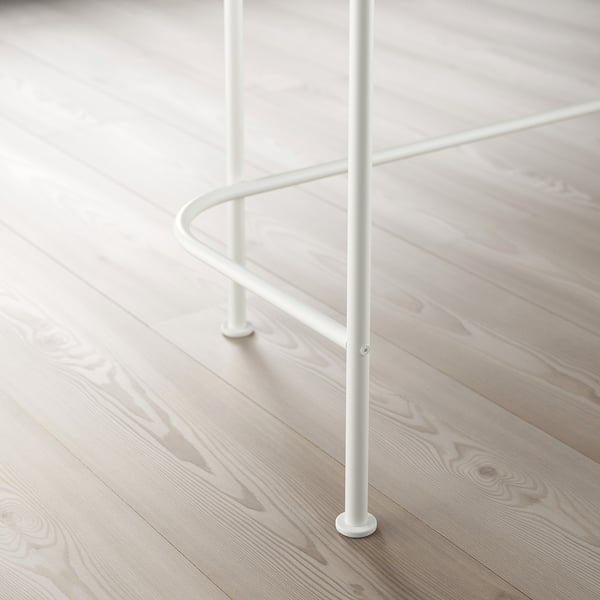 Metal table leg with adjustable feet on a wooden floor.