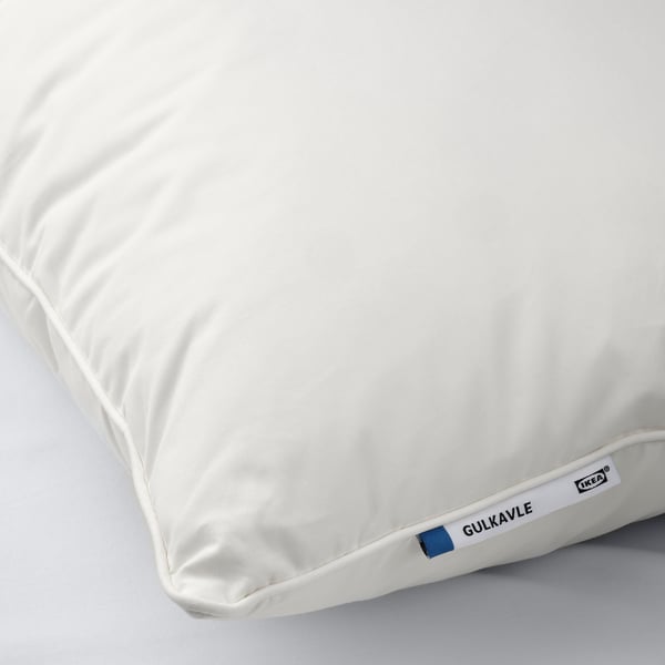 A plush, white pillow by IKEA labelled GULKAVLE, showcasing its high-quality, soft cotton and down filling.