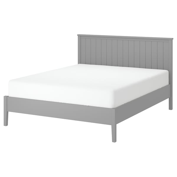 Minimalist grey bed, white mattress, vertical headboard grooves, sturdy wooden legs.