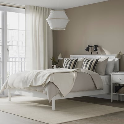 GULLABERG white bed with striped pillows, sturdy headboard, well-lit room.