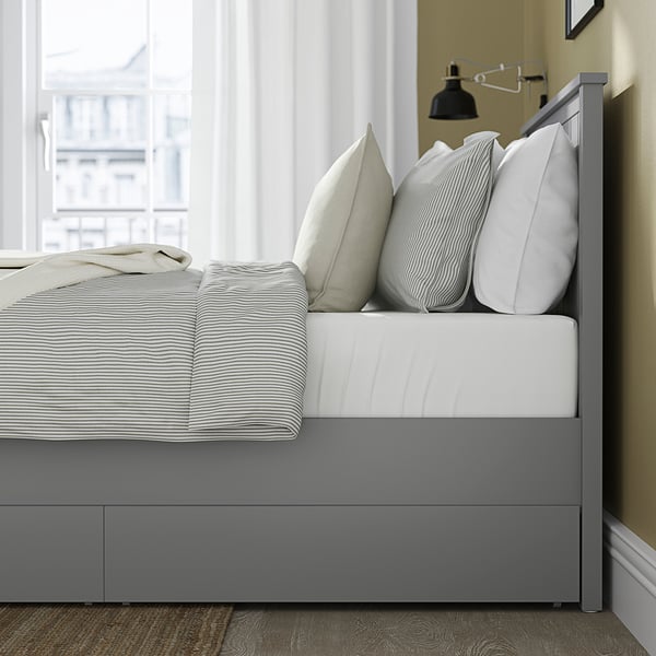Modern bed frame with two storage drawers. A high headboard and sturdy wooden legs.
