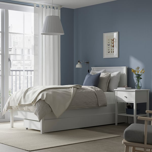 GULLABERG white wood bed frame. Modern classic with drawers, storage. Spacious room with chair, window, artwork.