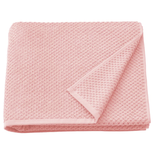Folded light pink GULVIAL cotton towel, soft, medium-thick, with textured surface, rectangular shape.