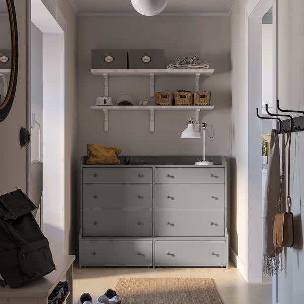 Entryway with grey HAUGA dresser, 6 drawers, white shelves, bags & scarves hooks, lamp.