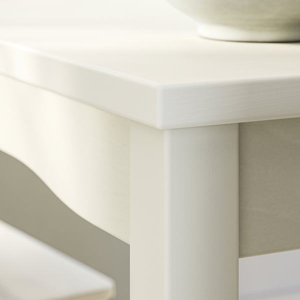 HAUGA white dining table corner, smooth edges, light wood.