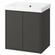 Modern black bathroom vanity with white sink, sleek design.