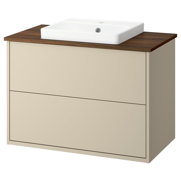 A beige HAVBÄCK bathroom vanity with a wooden countertop and a white ceramic sink. It has two drawers for storage.