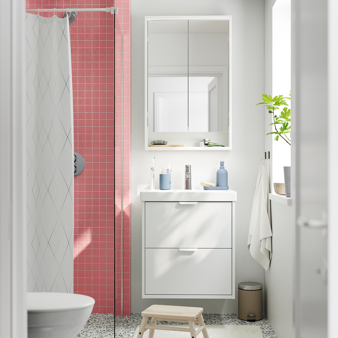 Bright bathroom with HAVBÄCK white vanity, two drawers, mirror cabinet, red tiles, glass shower. Minimalist design, practical storage.