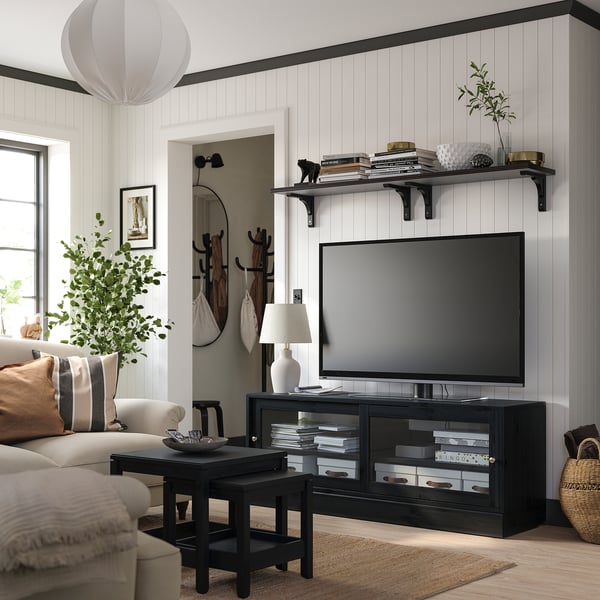 Modern living room with HAVSTA tv stand, large tv, beige sofa, plants, and lantern.
