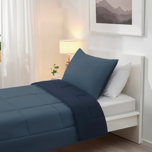 Bed with HEDFRYLE dark blue comforter & pillow, soft polyester, minimalist design, fits well in room.