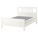 White HEMNES solid wood bed, sleek design, sturdy headboard, adjustable sides.