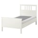 White HEMNES solid pine bed with high headboard and adjustable sides.